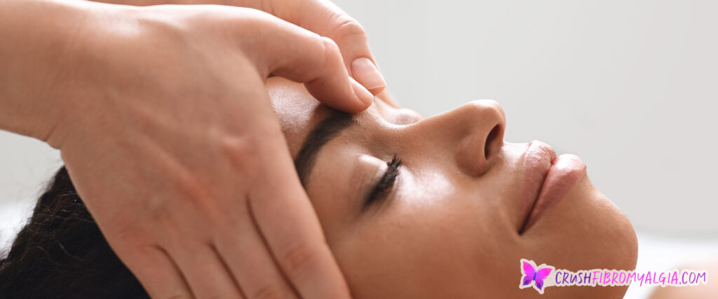 Woman receiving a head massage for migraine relief